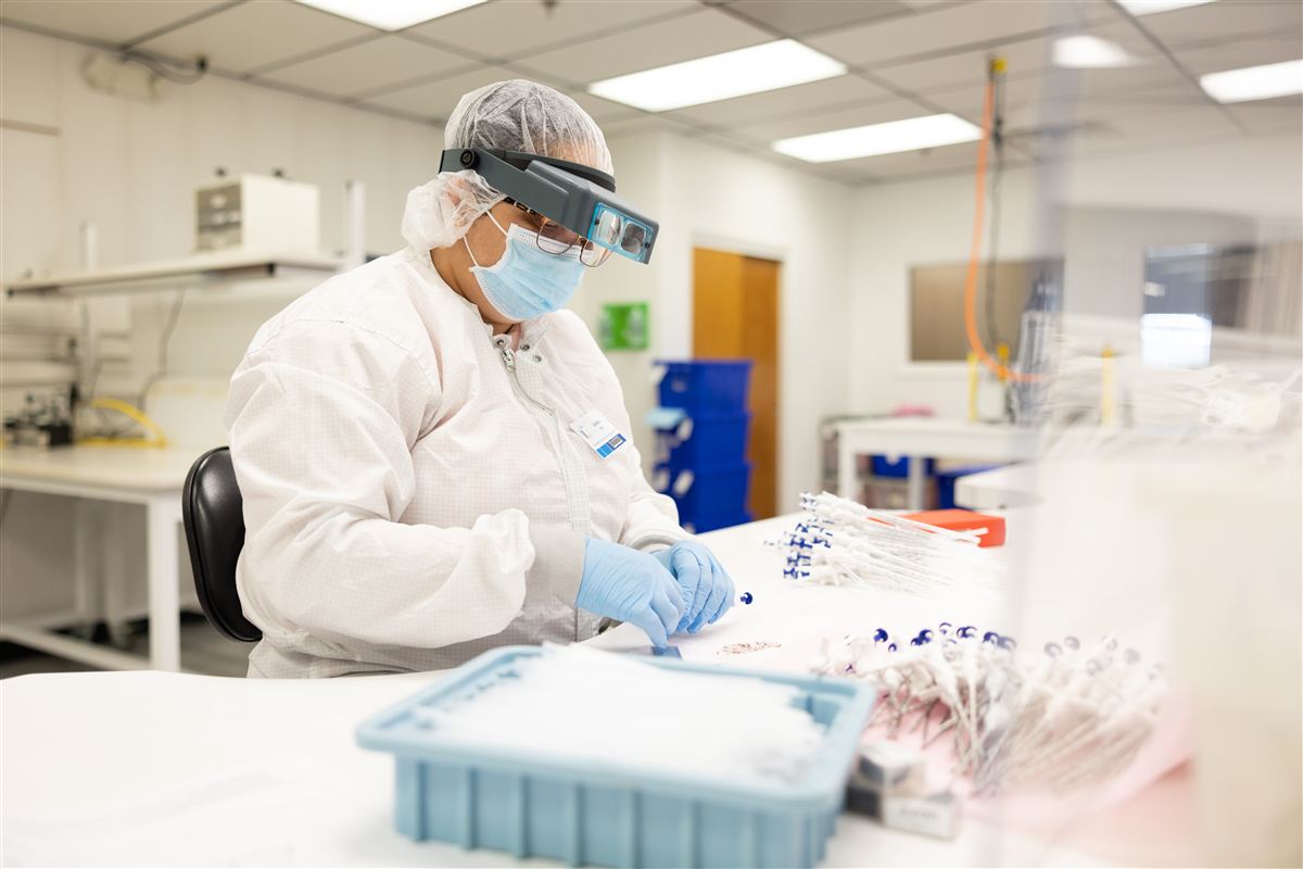 Ranfac cleanroom operator inspecting bone marrow needle assembly